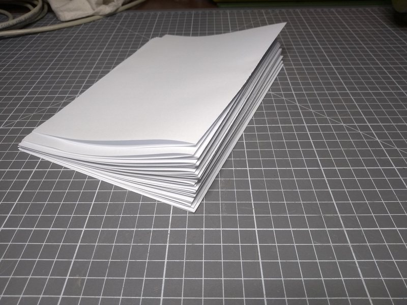 A stack of folded A4 paper.
